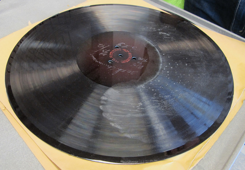 A lacquer disc damaged by mold after its sleeve was soaked in a flood.