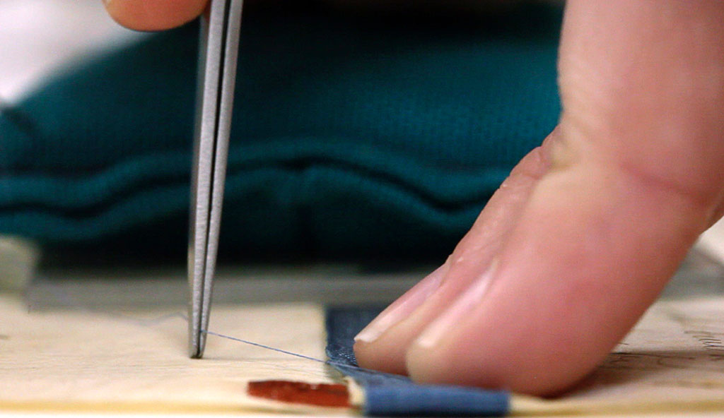 Securing the edges of the ribbon with toned hair silk