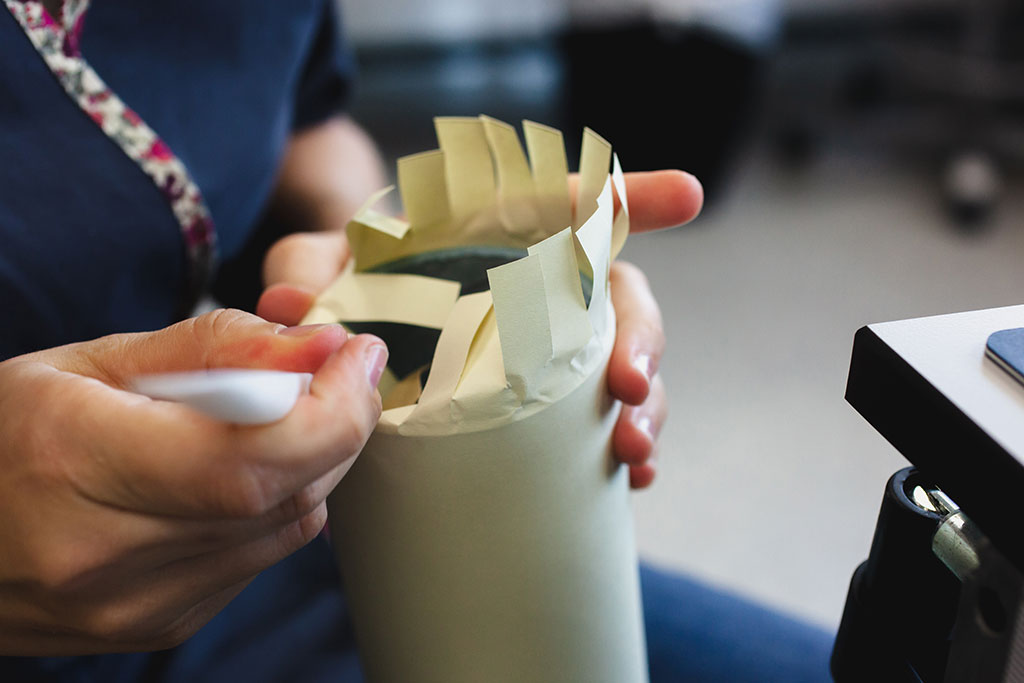 Feathering and wrapping the edges of the archival tube 