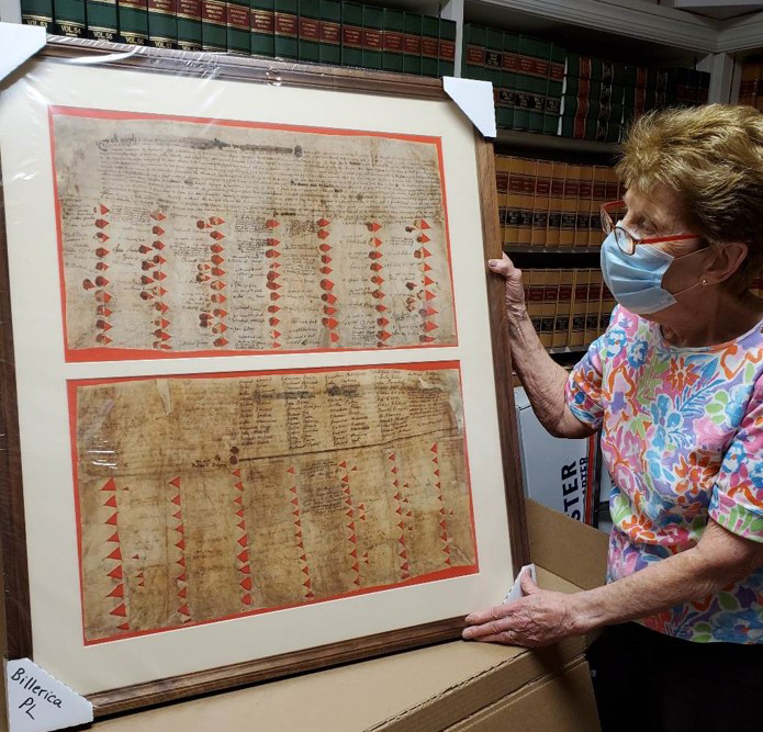 Billerica Town Hall’s framed facsimile of the Great Deed during unpacking by Shirley Schult.