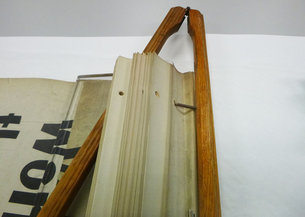 The top edge of each broadside was lined on the reverse with a 1-inch wide band of linen tape. The broadsides were attached to the clamp through punched holes and fastened to two metal pins.