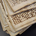 Iron gall ink has penetrated the leaves of a disbound manuscript.
