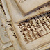 Disbound manuscript in which iron gall ink has significantly degraded the paper.
