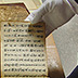 A bound volume of large maps with multiple folds, used heavily by a sea captain, displays both water and handling damage.