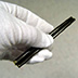 Early nitrate roll films tend to curl very tightly; in 1903, manufacturers began to coat the reverse side of the film with gelatin to prevent this problem.