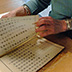 Before filming, materials are examined page by page to ensure that they are in the correct order and nothing is missing. Targets (guides to the content) are created and reel breaks are determined. During the review process, special instructions for the filmers are noted.
